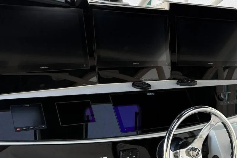  Yacht Photos Pics Dashboard of 2017 Hydra-Sports 4200 Siesta with multiple Garmin displays and steering wheel.