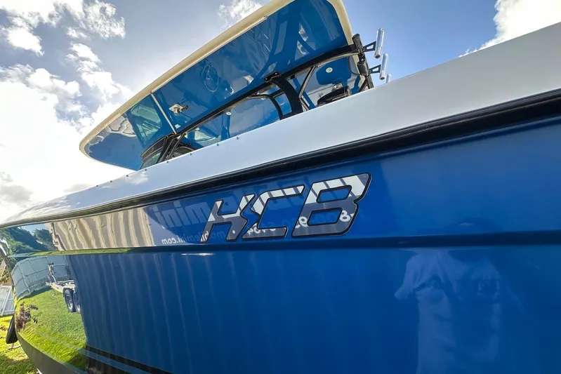  Yacht Photos Pics 2017 Hydra-Sports 4200 Siesta boat with HCB logo, blue hull, and clear sky background.