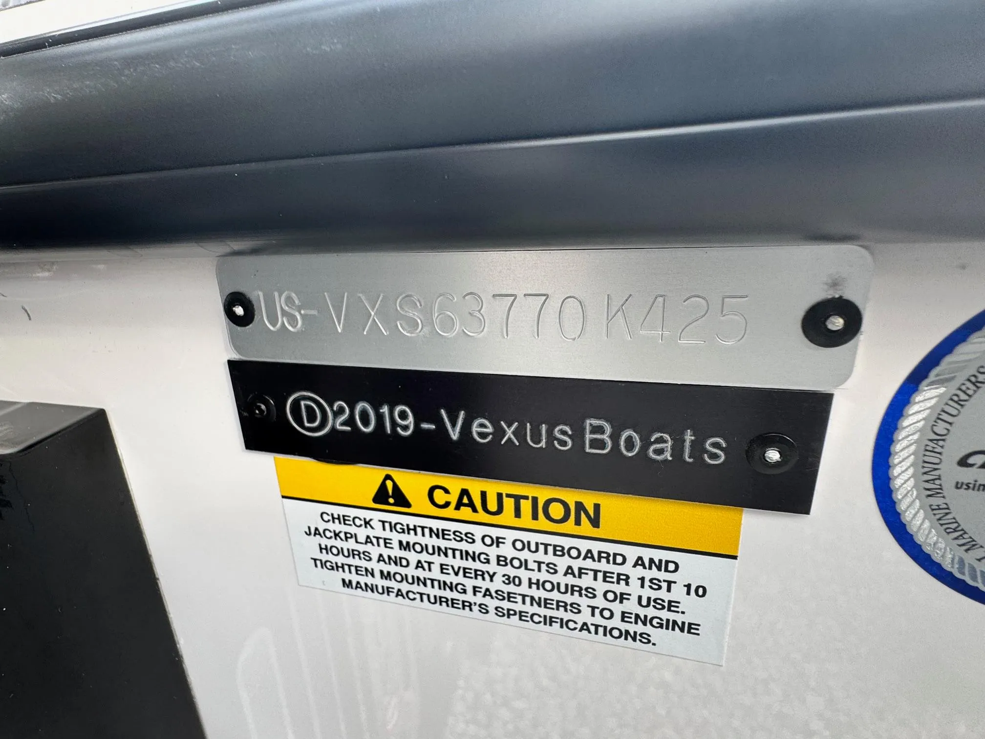 Vexus VXS21 2025 boat identification plate with caution label and serial number.