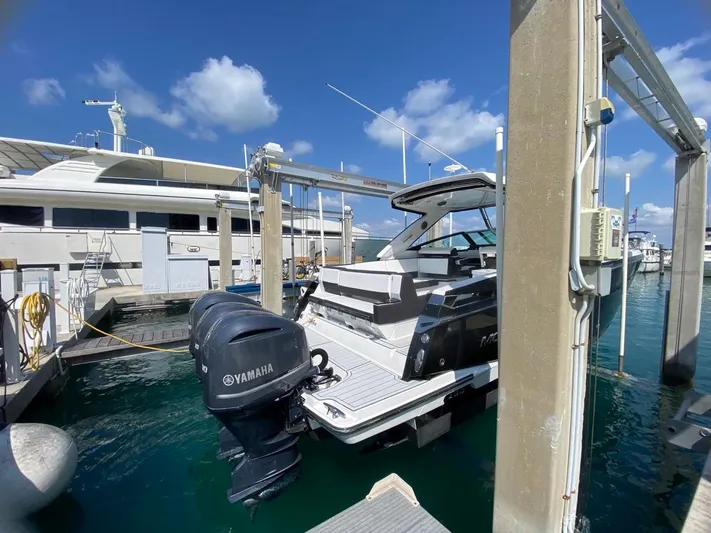  Yacht Photos Pics 2018 Monterey 385 SE boat docked with Yamaha outboard motor, under clear blue sky.