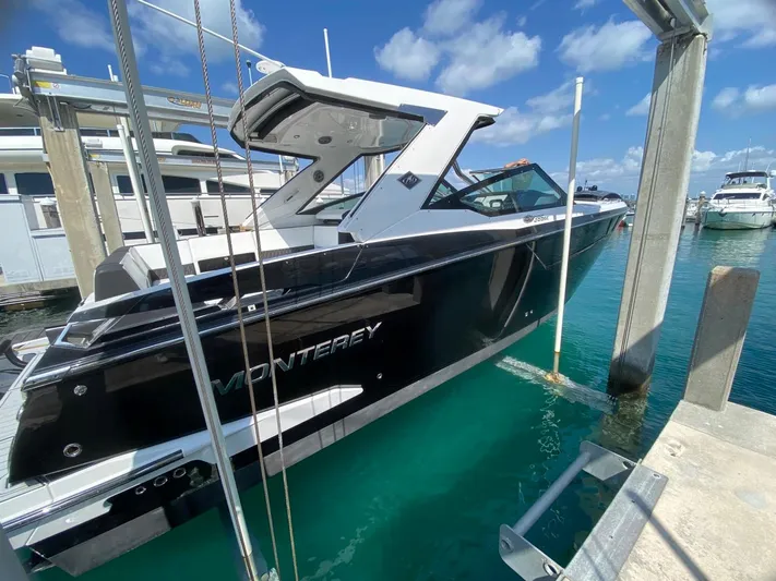  Yacht Photos Pics 2018 Monterey 385 SE boat docked in marina under clear blue sky.