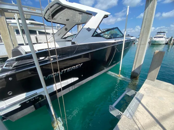  Yacht Photos Pics 2018 Monterey 385 SE boat docked in clear turquoise water under a sunny sky.