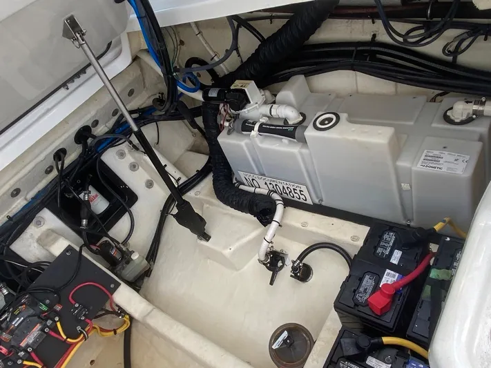  Yacht Photos Pics Engine compartment of a 2018 Monterey 385 SE boat, showing battery and fuel system components.