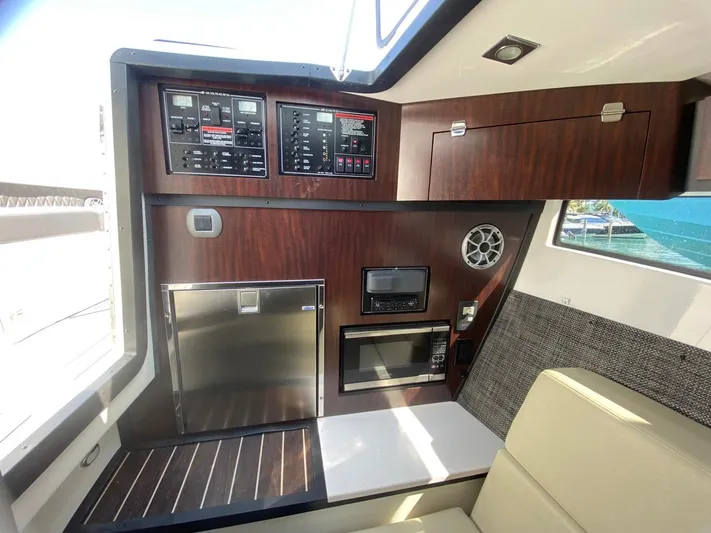  Yacht Photos Pics 2018 Monterey 385 SE yacht interior with control panels, fridge, and microwave.