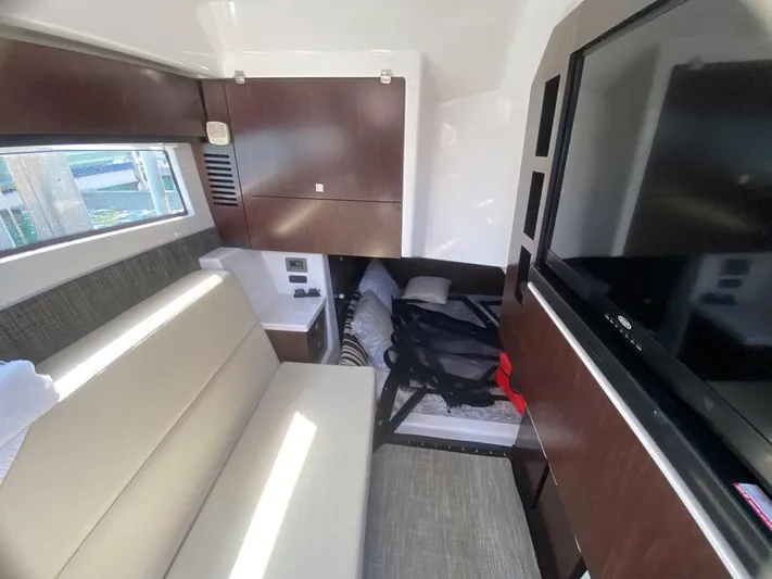  Yacht Photos Pics Interior of 2018 Monterey 385 SE yacht with sofa, TV, and storage cabinets.