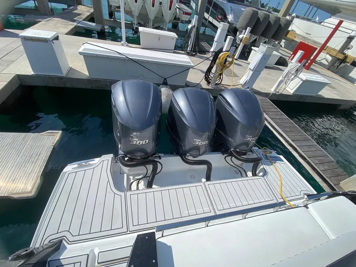  Yacht Photos Pics 2018 Monterey 385 SE boat with triple 300 horsepower outboard engines at a marina dock.
