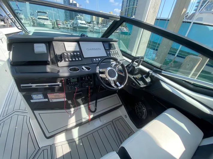  Yacht Photos Pics 2018 Monterey 385 SE boat cockpit with Garmin navigation, sleek design, and modern controls.