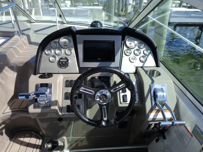  Yacht Photos Pics 2008 Cruisers Yachts 330 Express helm with steering wheel and control panel.