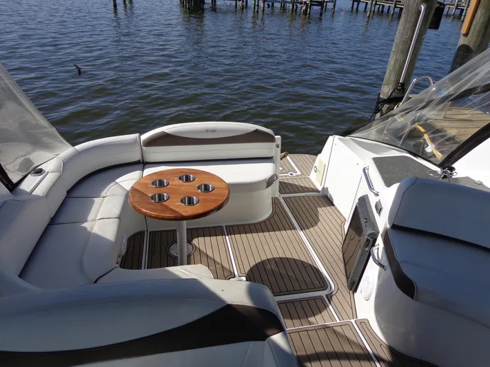  Yacht Photos Pics 2008 Cruisers Yachts 330 Express interior with seating and table, docked by the water.