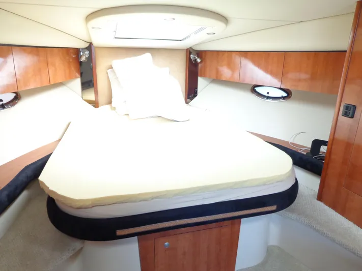  Yacht Photos Pics Luxurious cabin interior of 2008 Cruisers Yachts 330 Express with cozy bed and wooden accents.