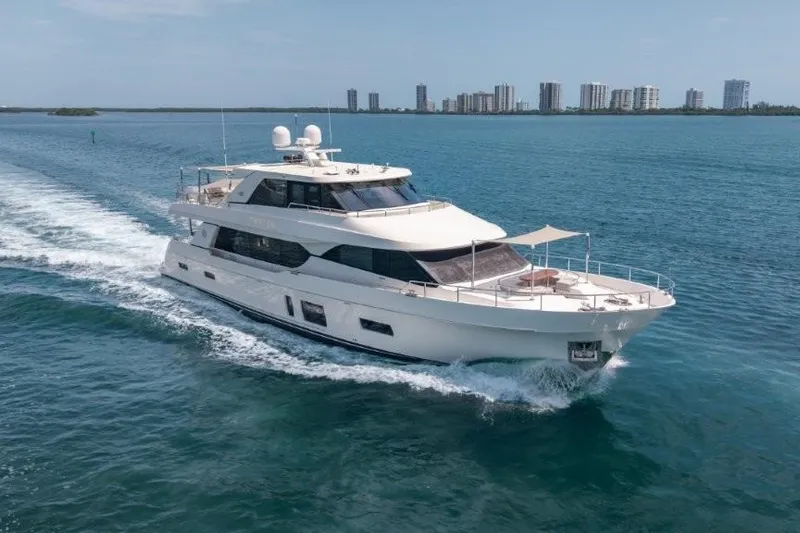Chindon Yacht Photos Pics 2017 Ocean Alexander Motor Yacht cruising on blue waters near a city skyline.