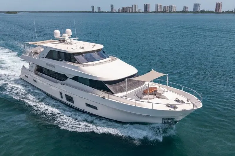 Chindon Yacht Photos Pics 2017 Ocean Alexander Motor Yacht cruising on open water near city skyline.