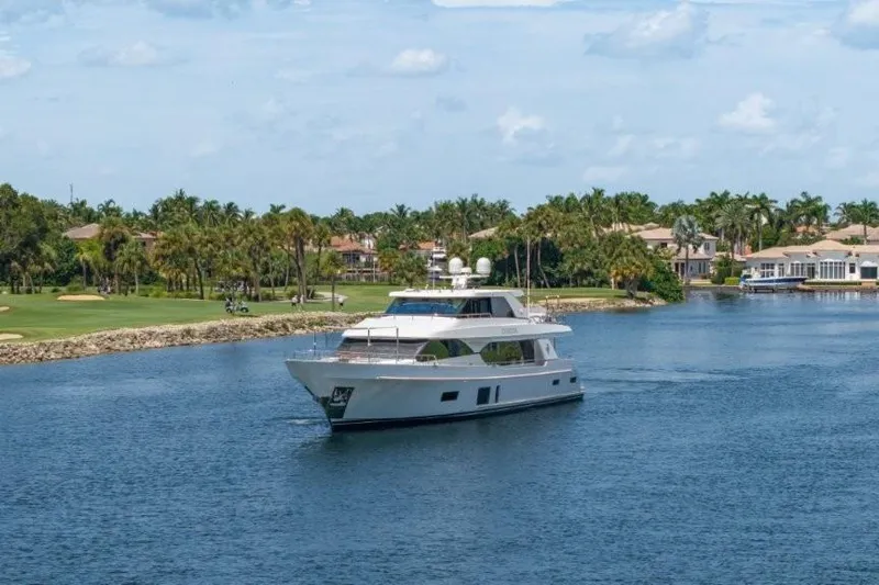 Chindon Yacht Photos Pics 2017 Ocean Alexander Motor Yacht cruising on a scenic waterway with palm trees.