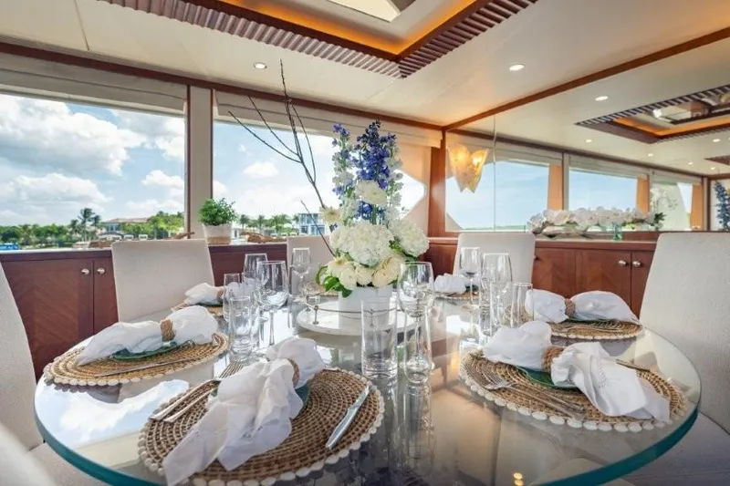Chindon Yacht Photos Pics Luxurious dining area on a 2017 Ocean Alexander motor yacht, featuring elegant table settings.