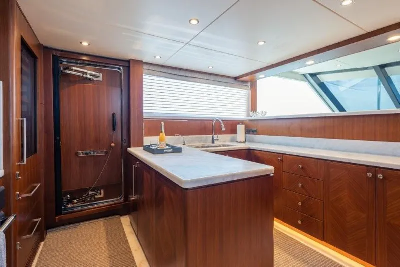 Chindon Yacht Photos Pics Luxurious 2017 Ocean Alexander Motor Yacht kitchen with wood cabinetry and modern fixtures.