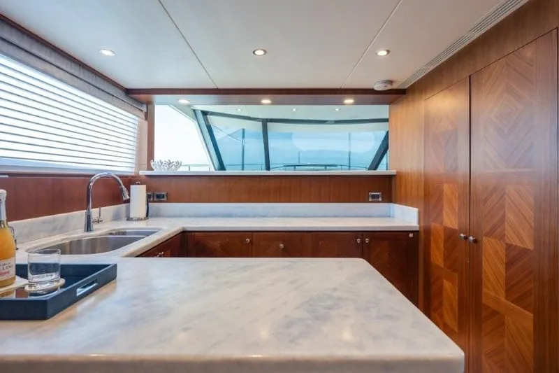 Chindon Yacht Photos Pics Luxurious kitchen interior of 2017 Ocean Alexander Motor Yacht with marble countertops.