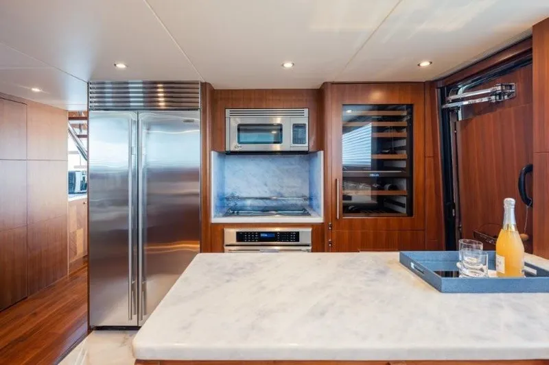 Chindon Yacht Photos Pics Luxurious kitchen in 2017 Ocean Alexander motor yacht with modern appliances and marble countertop.