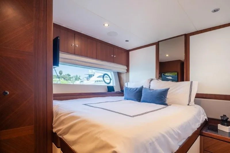 Chindon Yacht Photos Pics Luxurious bedroom interior of 2017 Ocean Alexander Motor Yacht with elegant wood finishes.