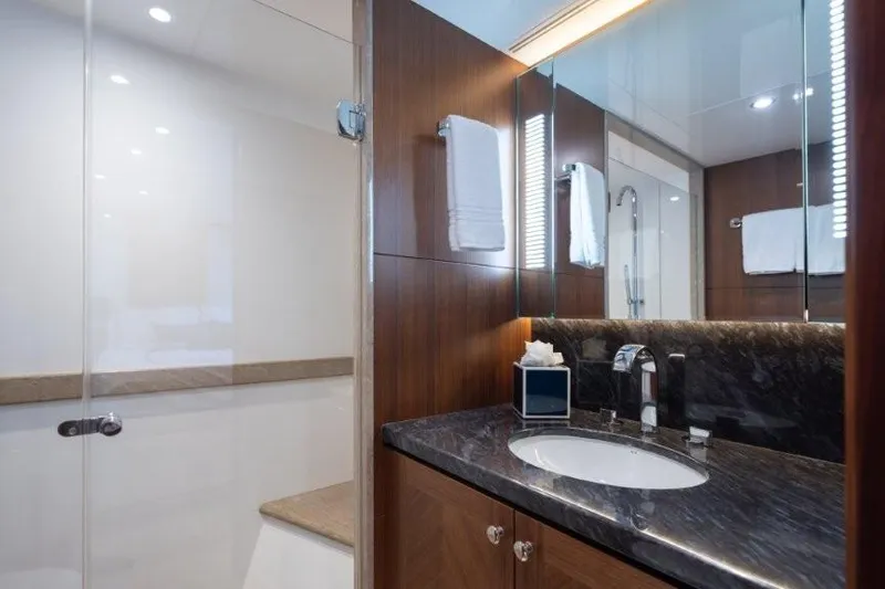 Chindon Yacht Photos Pics Luxurious bathroom in 2017 Ocean Alexander motor yacht with elegant wood and marble finishes.