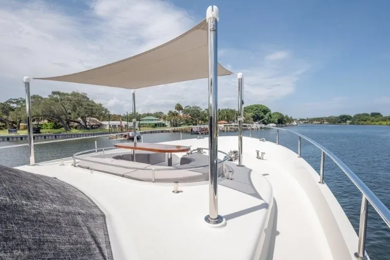 Chindon Yacht Photos Pics 2017 Ocean Alexander Motor Yacht deck with sunshade, cruising on a serene river.