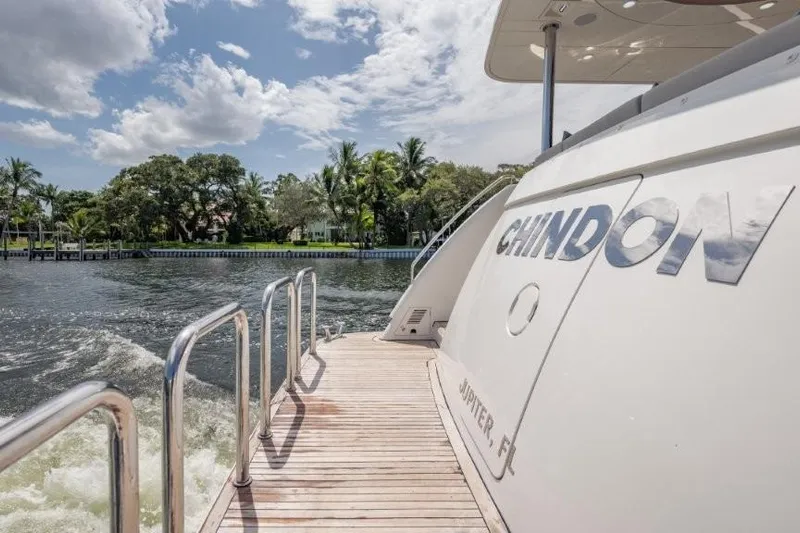 Chindon Yacht Photos Pics 2017 Ocean Alexander motor yacht on water, sunny day, lush greenery in background.
