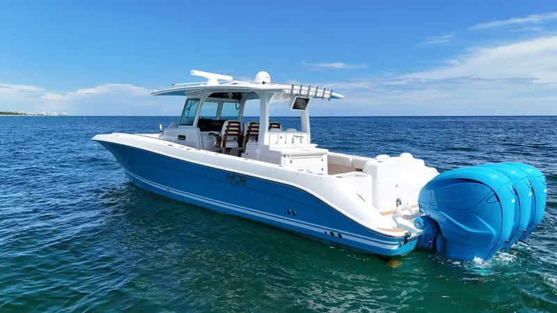  Yacht Photos Pics 2022 HCB Lujo boat with triple engines on open sea under clear blue sky.