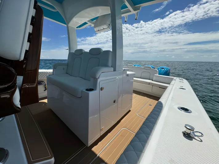  Yacht Photos Pics Luxurious 2022 HCB Lujo boat interior with plush seating, cruising on open water.