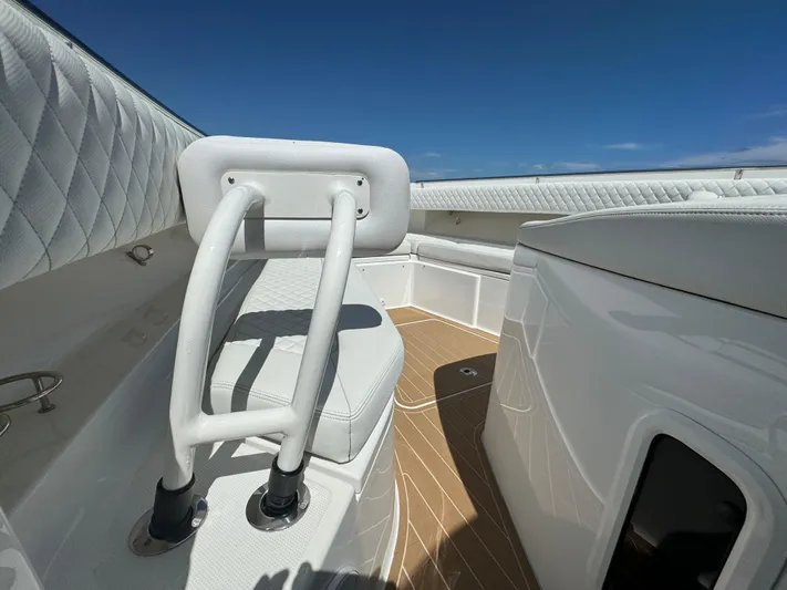  Yacht Photos Pics Luxurious 2022 HCB Lujo boat interior with white seating and wooden flooring.