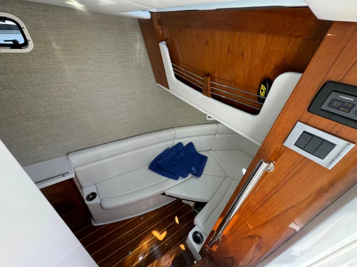  Yacht Photos Pics Luxurious 2022 HCB Lujo boat interior with white seating and wooden accents.