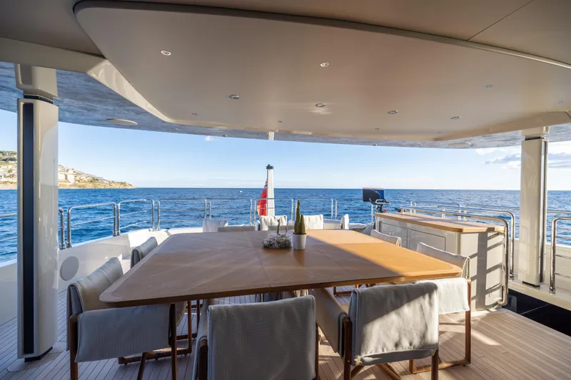 Stellamar Yacht Photos Pics Luxurious 2023 Cantiere Delle Marche RJ 115 yacht deck with dining area and ocean view.