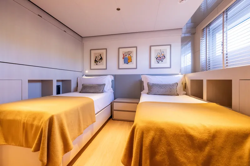 Stellamar Yacht Photos Pics Luxurious twin bedroom on 2023 Cantiere Delle Marche RJ 115 yacht, featuring modern decor and artwork.