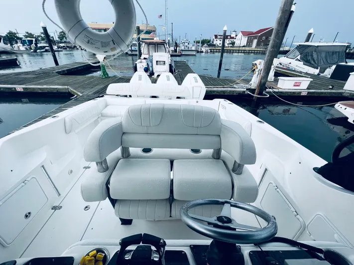 Donnalee2 Yacht Photos Pics 2004 Fountain 38 LX boat interior at marina, featuring helm and seating.