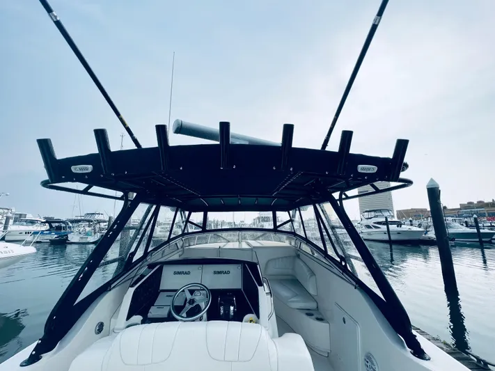 Donnalee2 Yacht Photos Pics 2004 Fountain 38 LX boat docked at a marina, view of the helm and seating area.