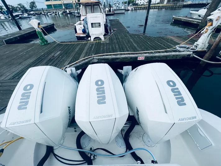 Donnalee2 Yacht Photos Pics 2004 Fountain 38 LX boat with triple Mercury outboard engines at a dock.