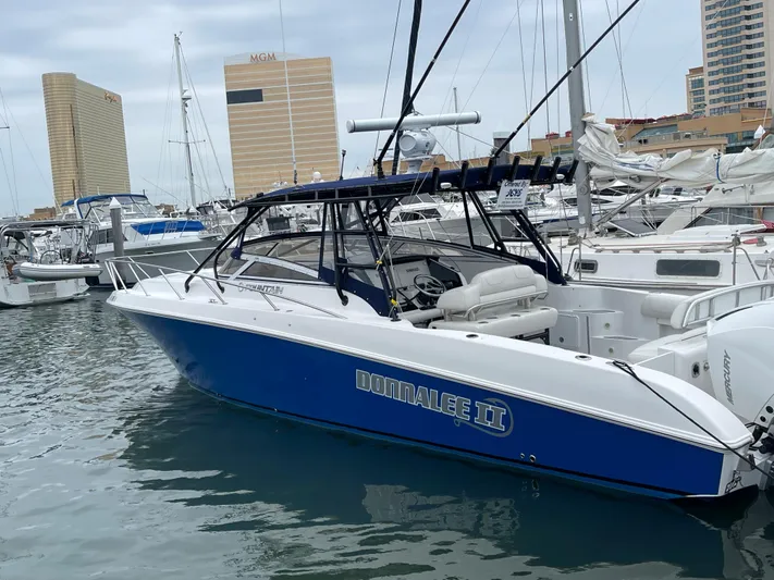 Donnalee2 Yacht Photos Pics 2004 Fountain 38 LX boat docked in marina with cityscape background.