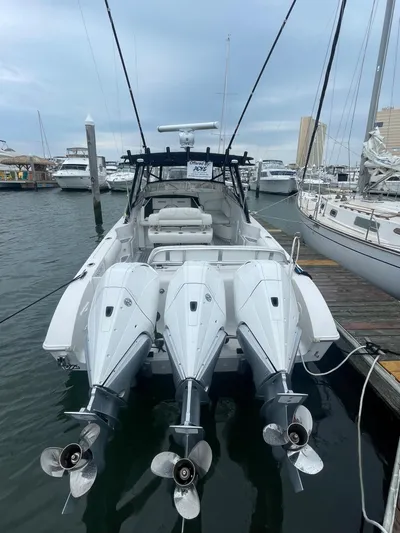 Donnalee2 Yacht Photos Pics 2004 Fountain 38 LX boat with triple outboard engines docked at a marina.