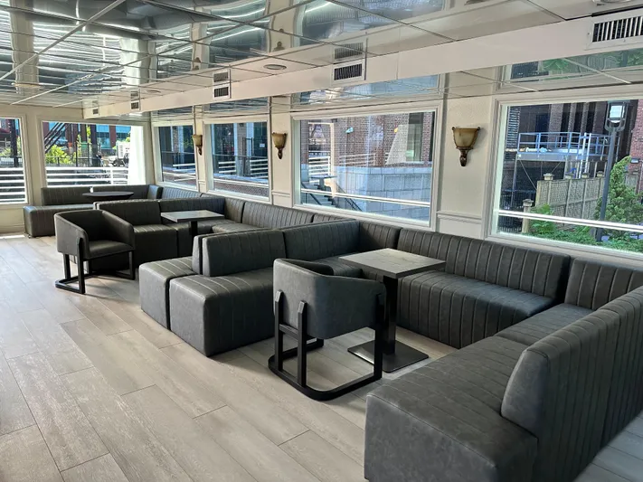 Sir Winston Yacht Photos Pics Luxurious interior of a 2007 custom passenger vessel with modern seating and large windows.