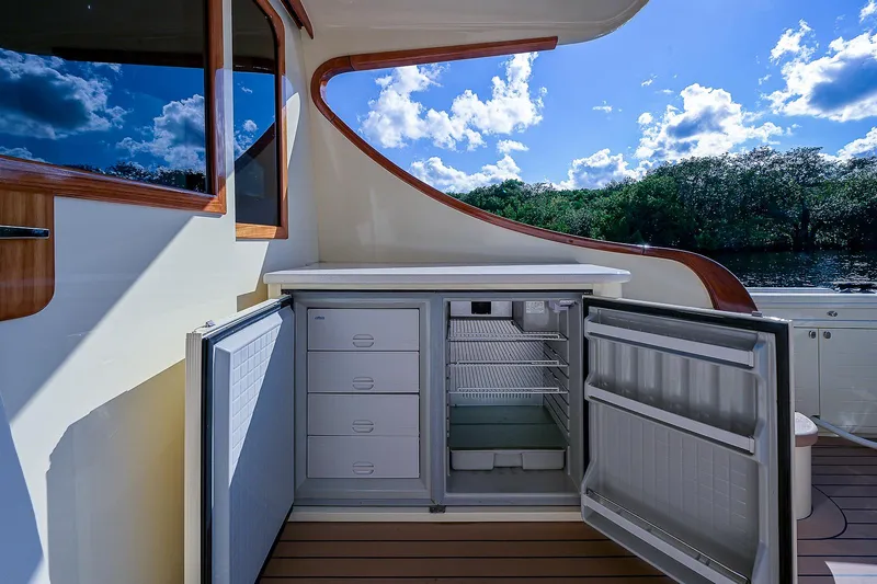Pb45 2017 Yacht Photos Pics Outdoor refrigerator on 2017 Palm Beach Motor Yachts PB45, open under sunny sky.