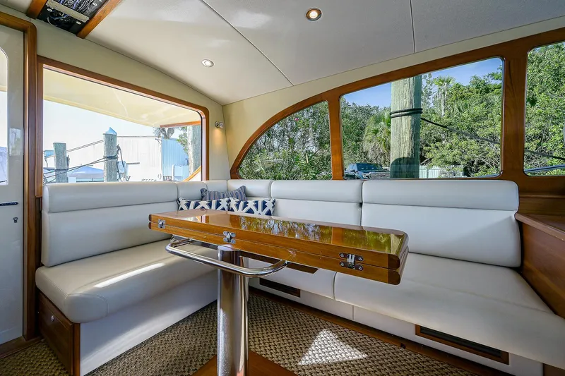Pb45 2017 Yacht Photos Pics Interior of 2017 Palm Beach Motor Yachts PB45 with elegant seating and wooden table.