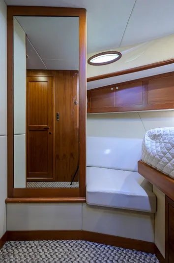 Pb45 2017 Yacht Photos Pics 2017 Palm Beach Motor Yachts PB45 cabin interior with wood accents and cozy seating.