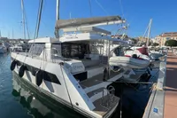 2022 Leopard 42 catamaran docked at marina under clear blue sky.