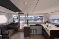 Modern interior of 2022 Leopard 42 catamaran with kitchen and seating area.