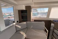 Modern interior of a 2022 Leopard 42 yacht with comfortable seating and large windows.