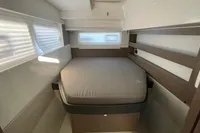 Modern bedroom interior in a 2022 Leopard 42 yacht, featuring a cozy bed and sleek design.
