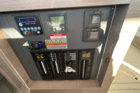 Electrical control panel on a 2022 Leopard 42 yacht, featuring switches and warning labels.