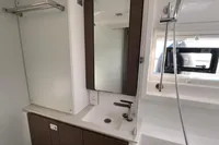 Modern bathroom interior in a 2022 Leopard 42 yacht, featuring a sleek sink and mirror.