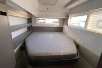 Modern bedroom interior in a 2022 Leopard 42 yacht with a cozy bed and windows.
