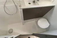 Modern bathroom in 2022 Leopard 42 yacht with shower, sink, and toilet.