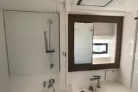 Modern bathroom in 2022 Leopard 42 yacht with shower and mirror.