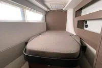 Modern cabin interior of 2022 Leopard 42 yacht with cozy bed and sleek design.